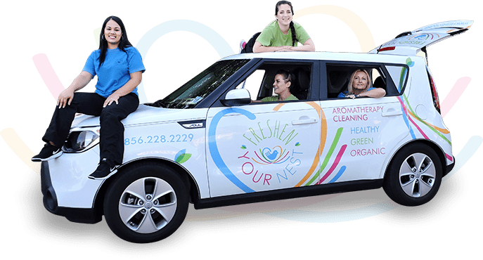 Staff members sitting in and around Freshen Your Nest company branded vehicle.