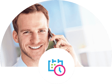A man happily holding a cell phone to his ear.