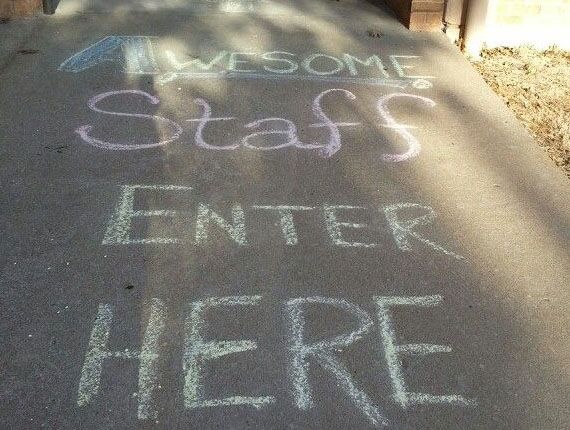 "Awesome Staff Enter Here" written in chalk on the sidewalk outside of Freshen Your Nest main office.